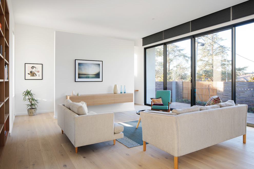 Photo of a contemporary formal open concept living room in Canberra - Queanbeyan with light hardwood floors, white walls and beige floor.