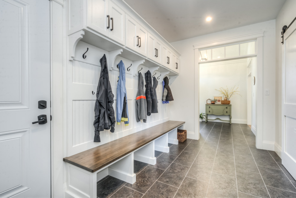 This is an example of a mid-sized country mudroom in Toronto with a single front door.