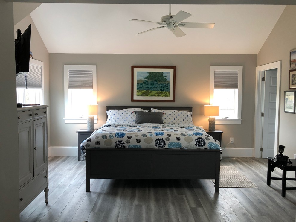 This is an example of a large modern master bedroom in Philadelphia with grey walls, vinyl floors, no fireplace and grey floor.