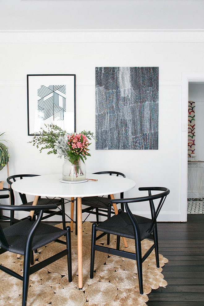 Inspiration for a mid-sized scandinavian open plan dining in Sydney with white walls, dark hardwood floors and brown floor.