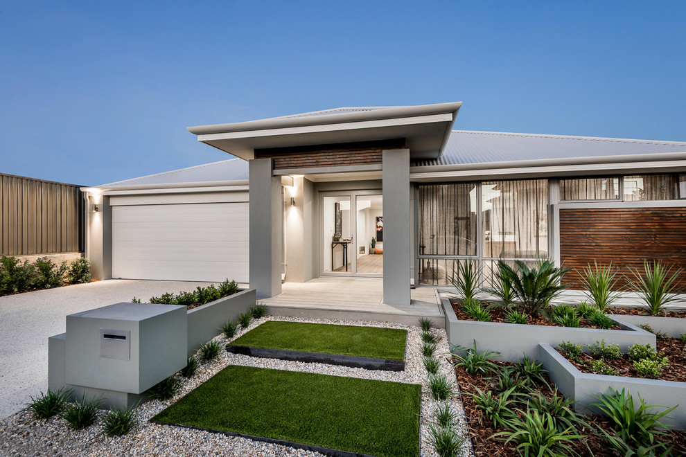 Photo of a mid-sized contemporary front yard full sun driveway in Perth with a container garden and gravel.