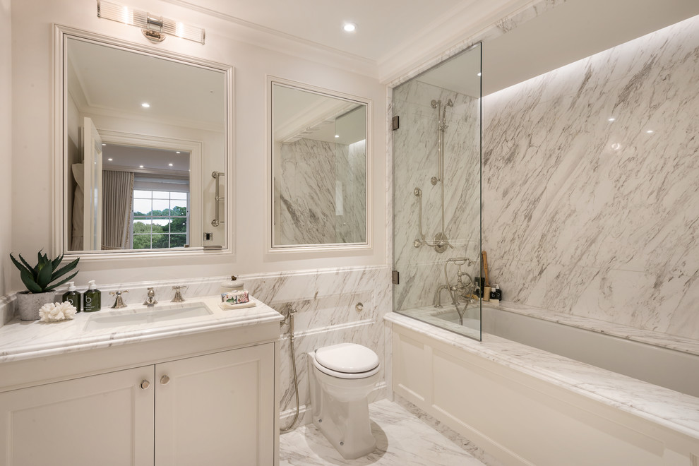 Mid-sized contemporary master bathroom in London with a drop-in tub, white walls, marble floors, a drop-in sink, marble benchtops, white floor and white benchtops.