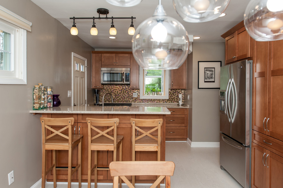 Inspiration for a large transitional galley cork floor eat-in kitchen remodel in DC Metro with an undermount sink, shaker cabinets, brown cabinets, quartz countertops, multicolored backsplash, glass tile backsplash and stainless steel appliances