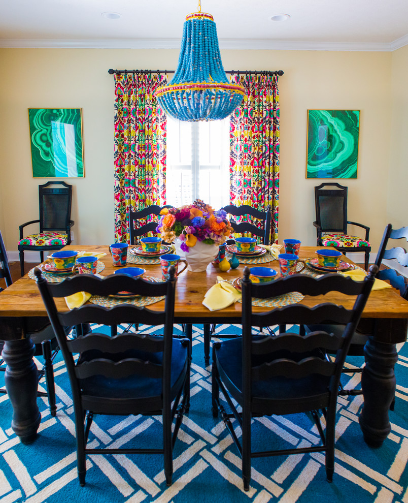 Mid-sized eclectic dining room in Atlanta with yellow walls, carpet and blue floor.