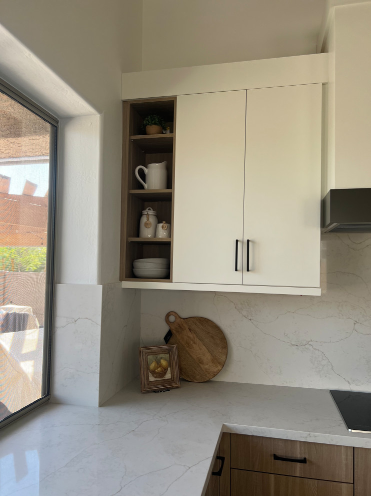 Kitchen - small transitional travertine floor, beige floor and vaulted ceiling kitchen idea in Phoenix with a drop-in sink, flat-panel cabinets, white cabinets, quartz countertops, white backsplash, quartz backsplash, stainless steel appliances, an island and white countertops