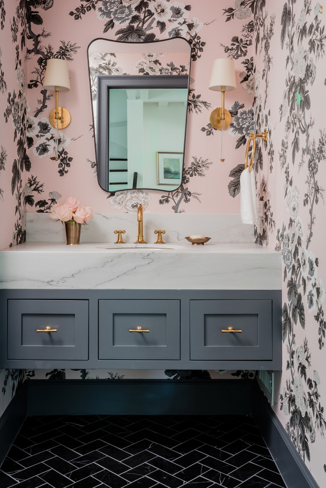 Photo of a mid-sized traditional powder room in Boston with ceramic floors, an undermount sink, marble benchtops, white benchtops, shaker cabinets, grey cabinets, pink walls, black floor, a floating vanity and wallpaper.