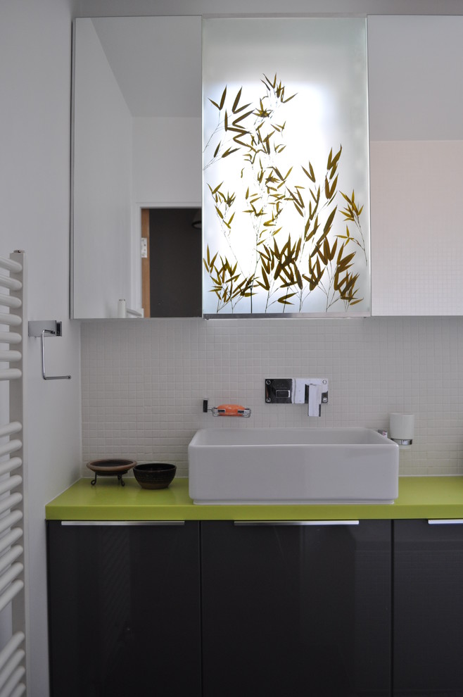 Inspiration for a contemporary bathroom in London with a vessel sink, flat-panel cabinets, black cabinets, white tile, mosaic tile and green benchtops.