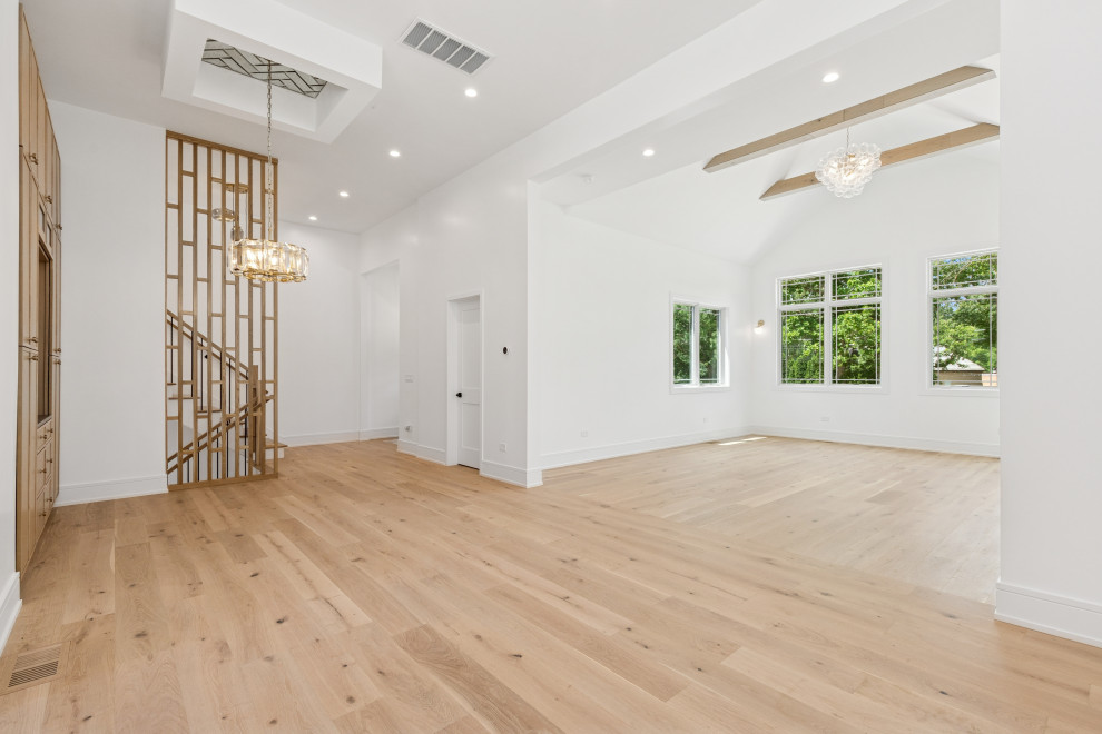 Symmetrical Custom Built-Ins Framing Sculptural Staircase