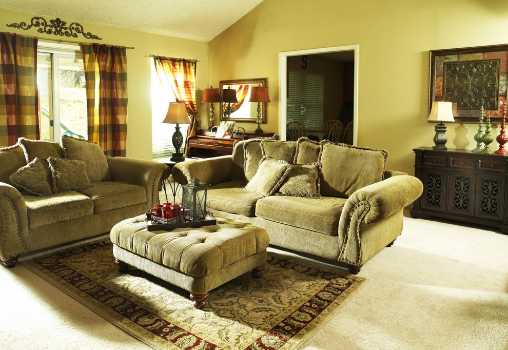 Design ideas for a traditional family room in Other with beige walls and carpet.