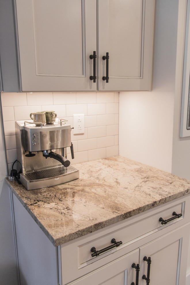Inspiration for a transitional medium tone wood floor kitchen remodel with granite countertops, subway tile backsplash and stainless steel appliances