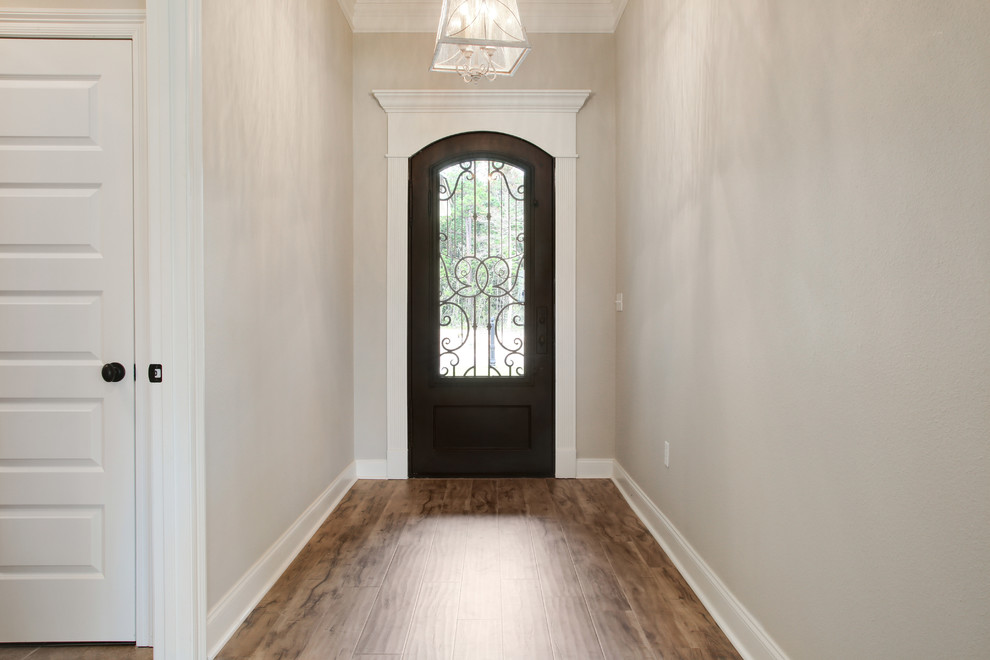 Design ideas for a mid-sized traditional foyer in Other with laminate floors and a single front door.
