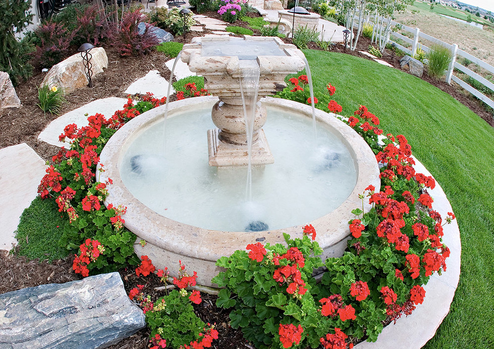 Inspiration for a mid-sized transitional full sun backyard stone water fountain landscape in Denver for spring.