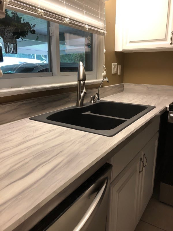 Small galley eat-in kitchen photo with laminate countertops and no island