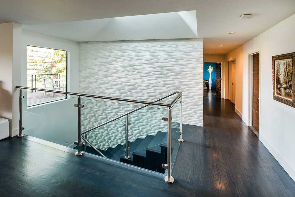 Inspiration for a mid-sized contemporary wood u-shaped staircase in San Francisco with glass risers and metal railing.