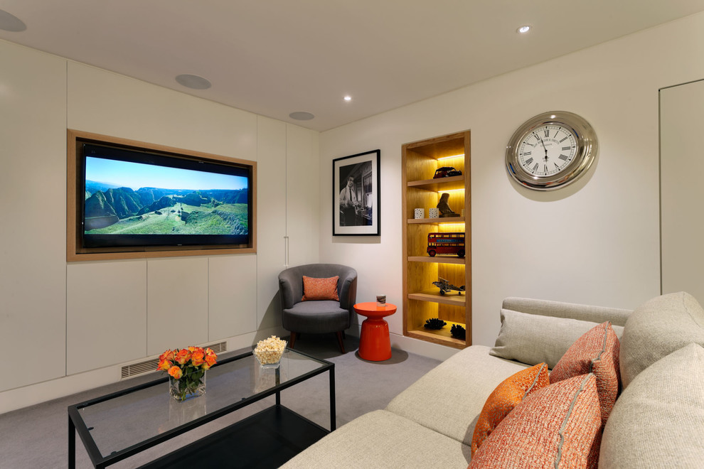 Inspiration for a small contemporary enclosed home theatre in London with white walls, carpet and a built-in media wall.