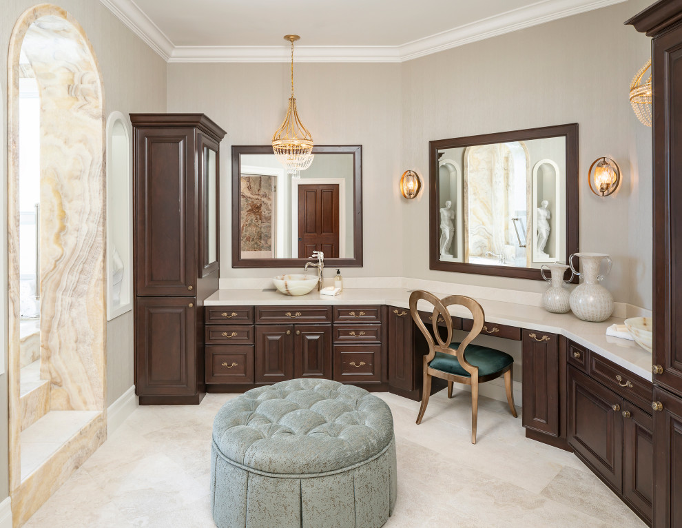 Inspiration for a large traditional master bathroom in Phoenix with raised-panel cabinets, dark wood cabinets, an undermount tub, a curbless shower, a bidet, beige tile, stone slab, beige walls, marble floors, a vessel sink, marble benchtops, beige floor, a hinged shower door, beige benchtops, a shower seat, a double vanity, a built-in vanity and wallpaper.