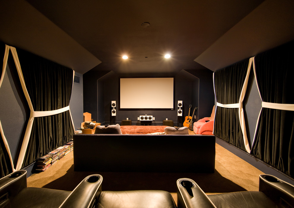 This is an example of a contemporary home theatre in Other with black walls.