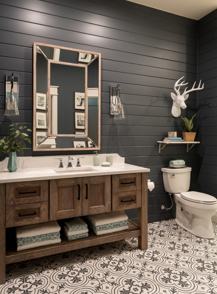 Inspiration for a small beach style 3/4 bathroom with shaker cabinets, medium wood cabinets, an alcove shower, a two-piece toilet, white tile, black walls, cement tiles, an undermount sink, engineered quartz benchtops, multi-coloured floor, a hinged shower door and cement tile.