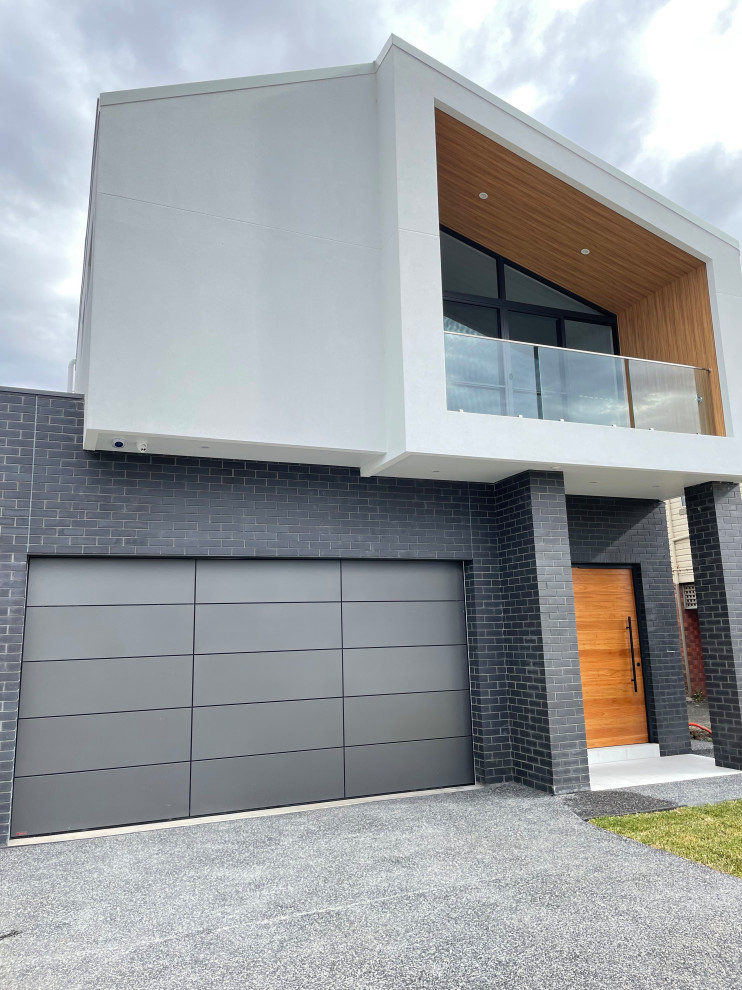 Design ideas for a contemporary garage in Newcastle - Maitland with three or more cars.