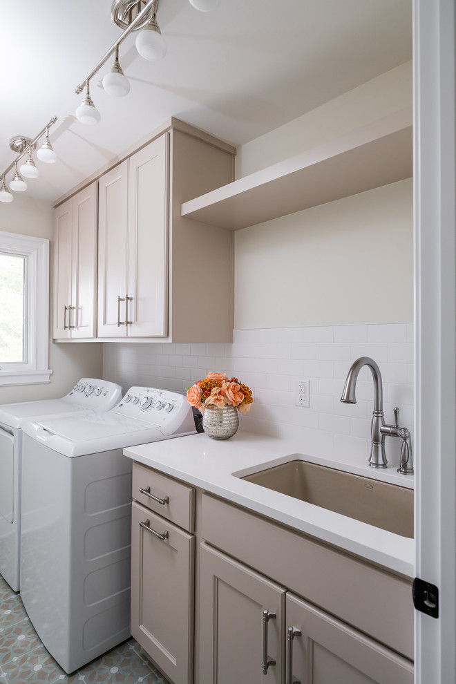 This is an example of a mid-sized contemporary dedicated laundry room in Indianapolis with shaker cabinets, quartz benchtops, white walls, medium hardwood floors, a side-by-side washer and dryer and white benchtop.