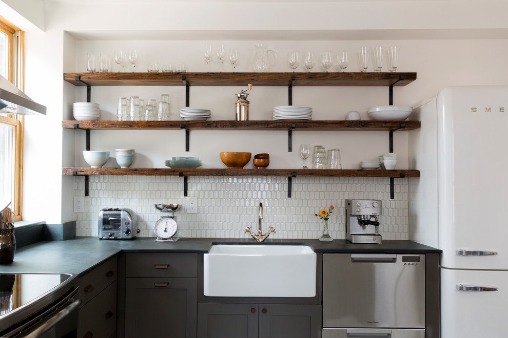 Inspiration for a mid-sized contemporary l-shaped eat-in kitchen in Philadelphia with a farmhouse sink, grey cabinets, white splashback, ceramic splashback, stainless steel appliances, porcelain floors, no island, multi-coloured floor, shaker cabinets and grey benchtop.