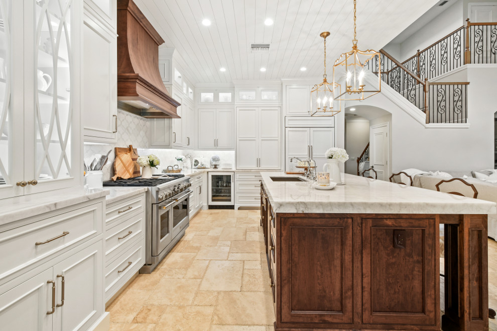 Design ideas for a mid-sized l-shaped open plan kitchen in Other with an undermount sink, beaded inset cabinets, white cabinets, quartzite benchtops, white splashback, marble splashback, panelled appliances, limestone floors, with island, beige floor, white benchtop and wood.