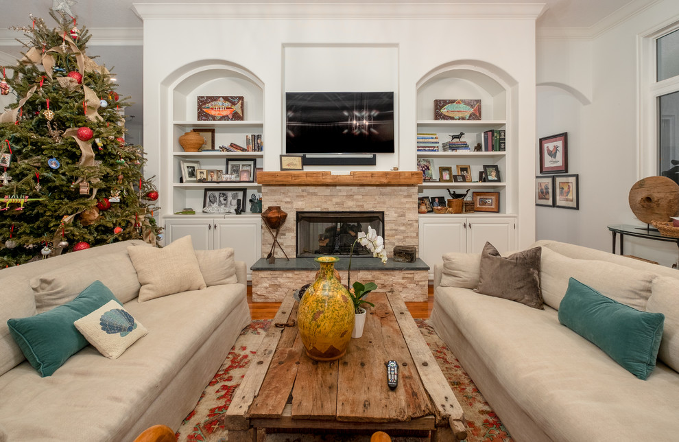 Large eclectic formal open concept living room in Tampa with grey walls, medium hardwood floors, a standard fireplace, a stone fireplace surround, no tv and brown floor.