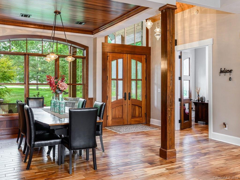 Example of a large mountain style medium tone wood floor great room design with beige walls