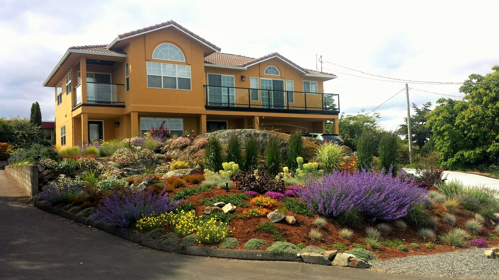 Inspiration for a large mediterranean front yard full sun xeriscape for summer in Other with a garden path and gravel.