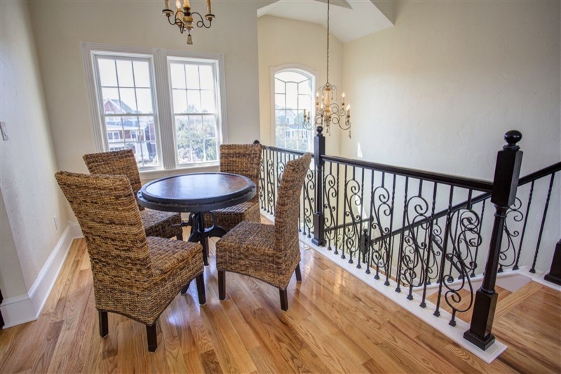 Mid-sized transitional medium tone wood floor great room photo with beige walls and no fireplace