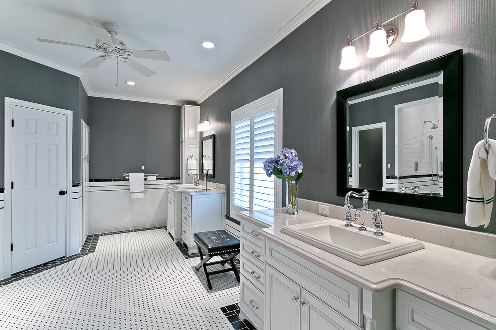 Inspiration for a mid-sized traditional master bathroom in Dallas with a drop-in sink, white cabinets, solid surface benchtops, a two-piece toilet, white tile, porcelain tile, porcelain floors and raised-panel cabinets.