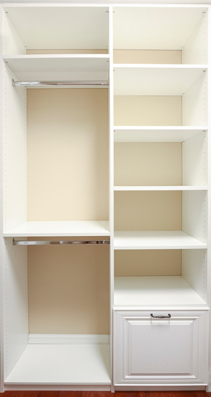 This is an example of a mid-sized traditional gender-neutral walk-in wardrobe in Miami with open cabinets, white cabinets and dark hardwood floors.
