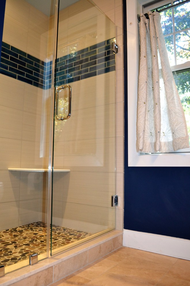 Photo of a mid-sized beach style bathroom in Baltimore with an alcove shower, a two-piece toilet, beige tile, porcelain tile, blue walls, marble floors, an undermount sink, beige floor and a hinged shower door.