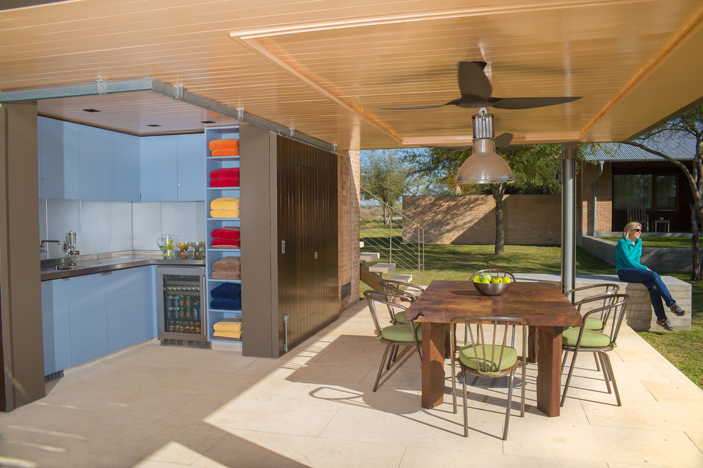 This is an example of a contemporary patio in Austin with natural stone pavers and a gazebo/cabana.