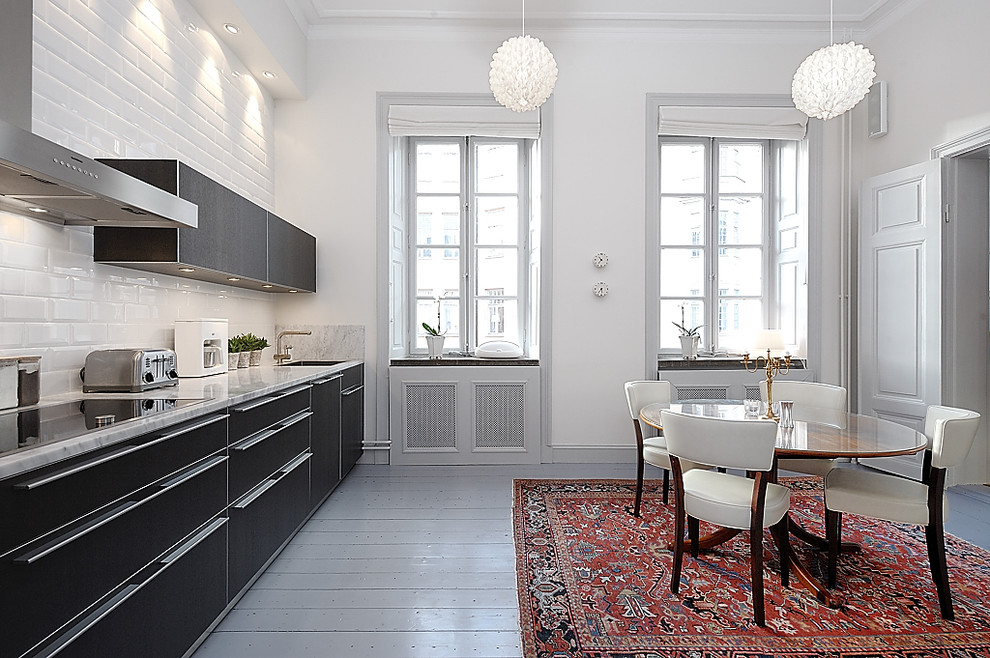 Photo of a mid-sized contemporary eat-in kitchen in Stockholm with a single-bowl sink, open cabinets, black cabinets, marble benchtops, black appliances, painted wood floors and no island.