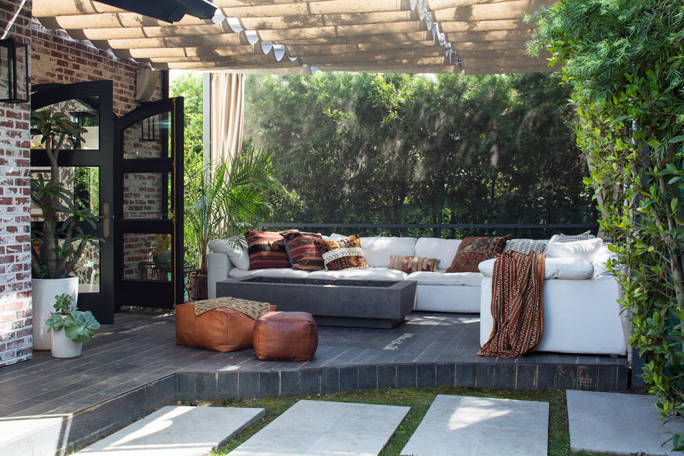 Large contemporary backyard patio in Los Angeles with concrete pavers and an awning.