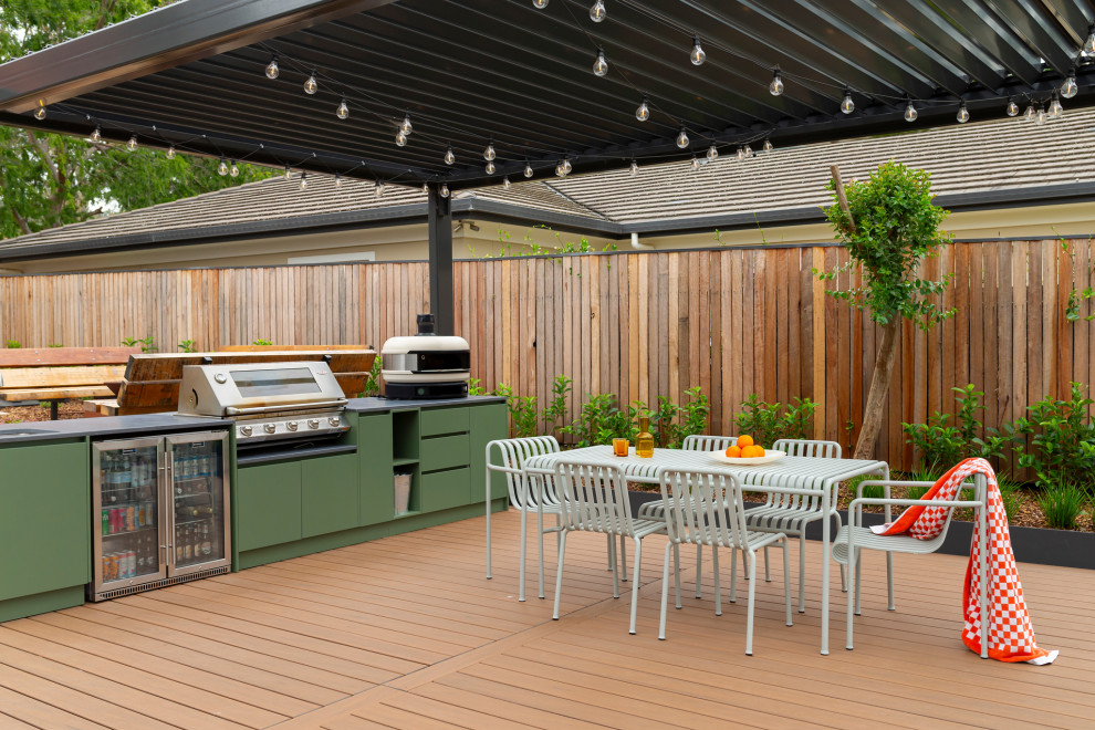 Design ideas for a contemporary backyard and ground level deck in Canberra - Queanbeyan with an outdoor kitchen and a pergola.