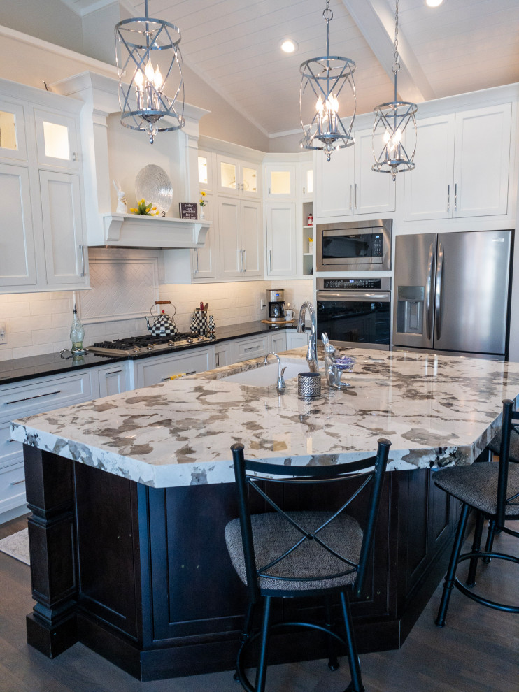 Large transitional l-shaped medium tone wood floor, gray floor and shiplap ceiling eat-in kitchen photo with an undermount sink, flat-panel cabinets, white cabinets, granite countertops, yellow backsplash, subway tile backsplash, stainless steel appliances, an island and white countertops