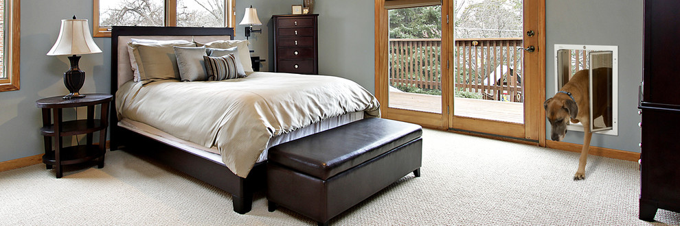 This is an example of a traditional master bedroom in Melbourne with grey walls and carpet.