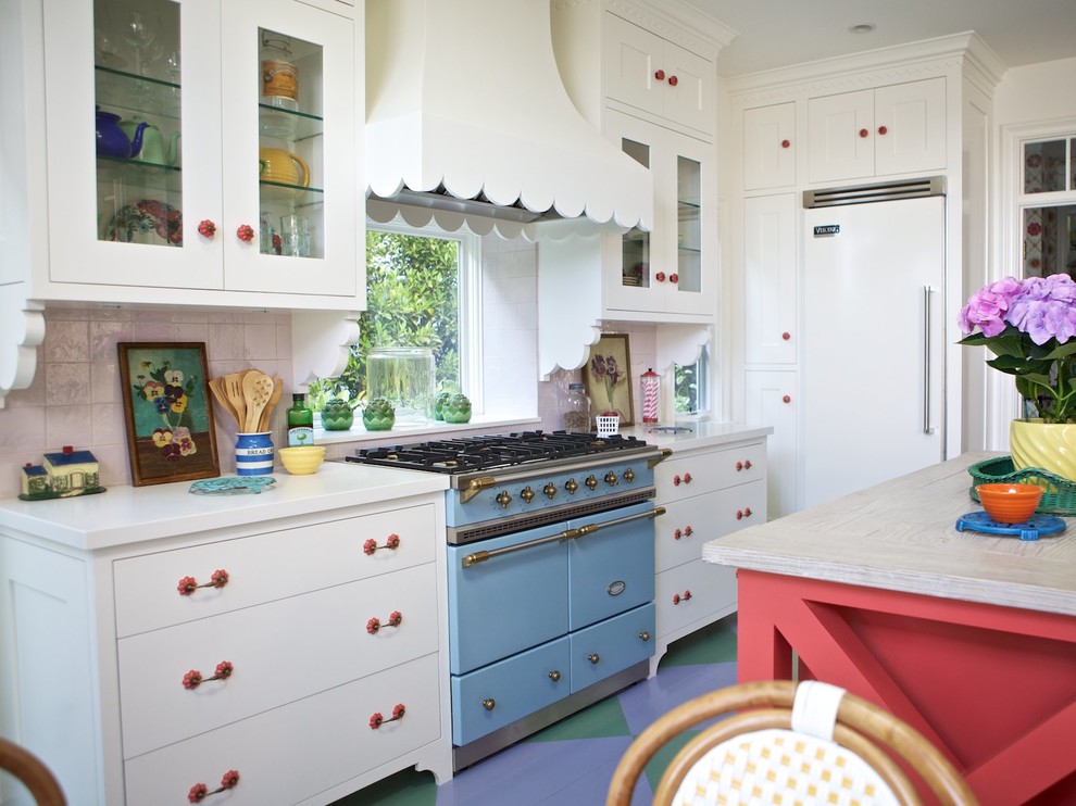 This is an example of an eclectic open plan kitchen in Los Angeles with white cabinets, wood benchtops, ceramic splashback, painted wood floors, coloured appliances and shaker cabinets.