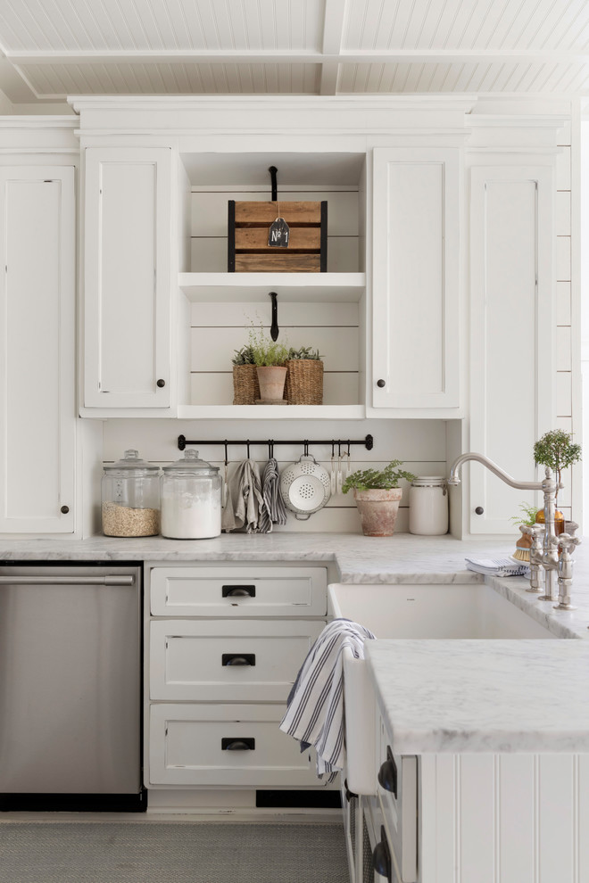 This is an example of a mid-sized country u-shaped eat-in kitchen in Minneapolis with a farmhouse sink, white cabinets, white splashback, timber splashback, with island, white benchtop, recessed-panel cabinets and stainless steel appliances.