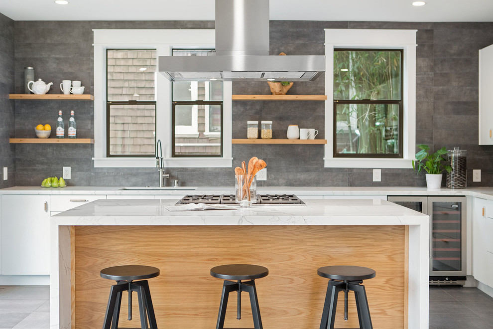 Photo of a large contemporary l-shaped open plan kitchen in San Francisco with an undermount sink, flat-panel cabinets, white cabinets, grey splashback, stainless steel appliances, with island, grey floor, marble benchtops and white benchtop.