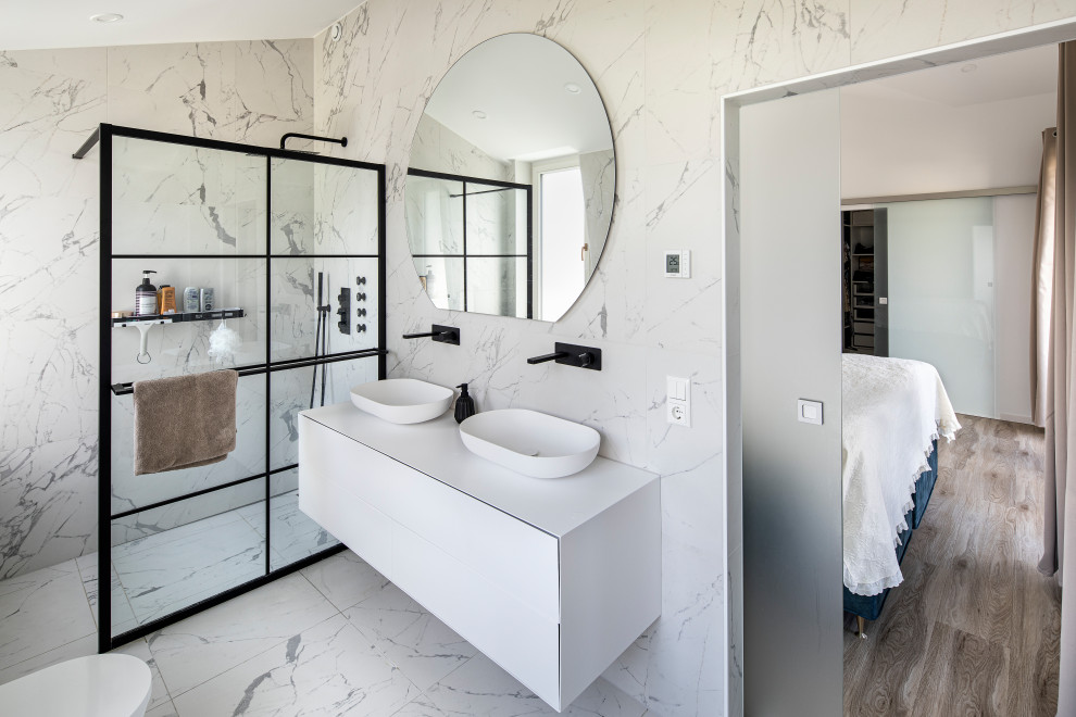 Photo of a medium sized contemporary shower room bathroom in Berlin with flat-panel cabinets, white cabinets, a built-in shower, a two-piece toilet, white tiles, marble tiles, white walls, marble flooring, a vessel sink, stainless steel worktops, white floors, an open shower, white worktops, double sinks and a floating vanity unit.
