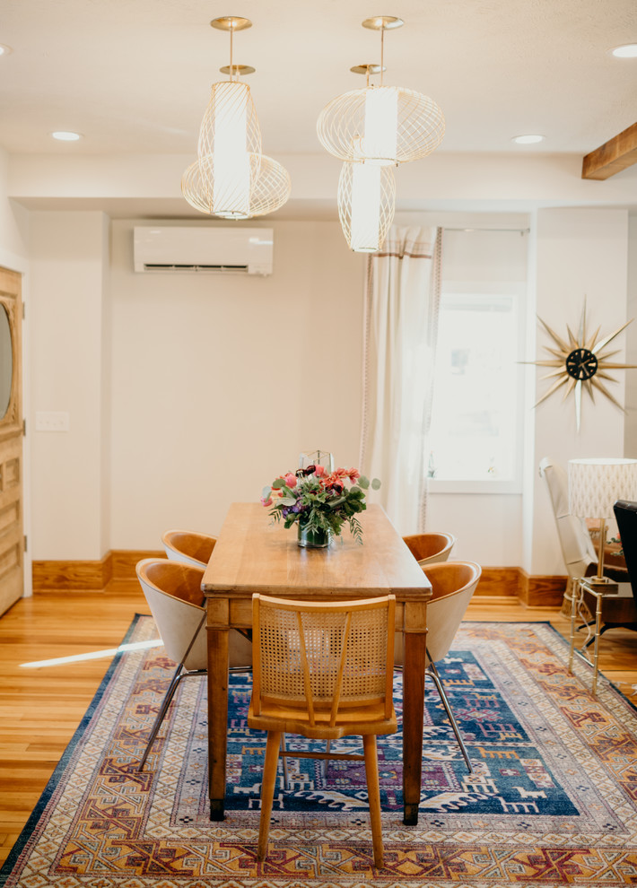 Photo of a midcentury open plan dining in Other with white walls, light hardwood floors and beige floor.