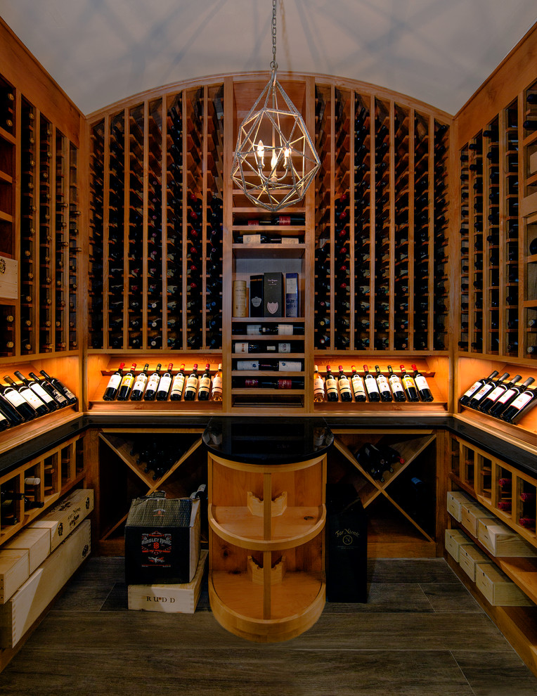 This is an example of a mid-sized traditional wine cellar in Austin with porcelain floors, storage racks and brown floor.