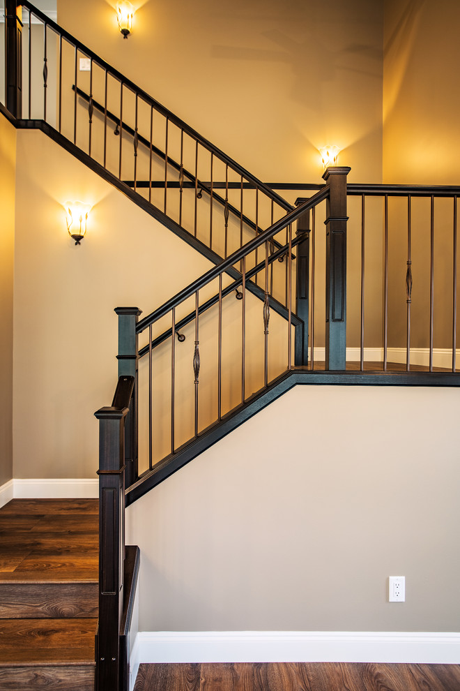 Mid-sized traditional wood l-shaped staircase in Vancouver with wood risers and metal railing.