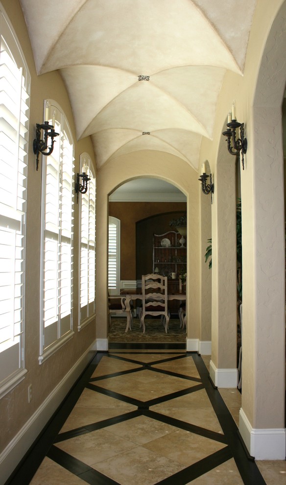 Inspiration for a traditional hallway in Houston with beige walls and multi-coloured floor.