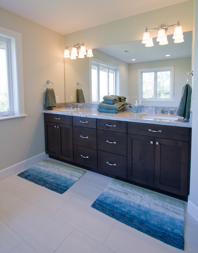 Inspiration for a large contemporary master bathroom in Salt Lake City with shaker cabinets, dark wood cabinets, a drop-in tub, a corner shower, green walls, porcelain floors, an undermount sink and granite benchtops.