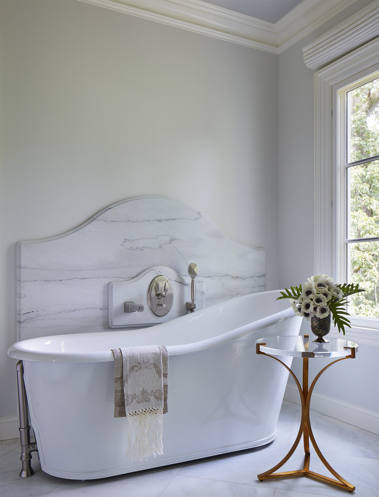 Inspiration for a large mediterranean master bathroom in Minneapolis with a freestanding tub, white walls, marble floors, marble benchtops, white floor, furniture-like cabinets, blue cabinets, gray tile, marble and an undermount sink.