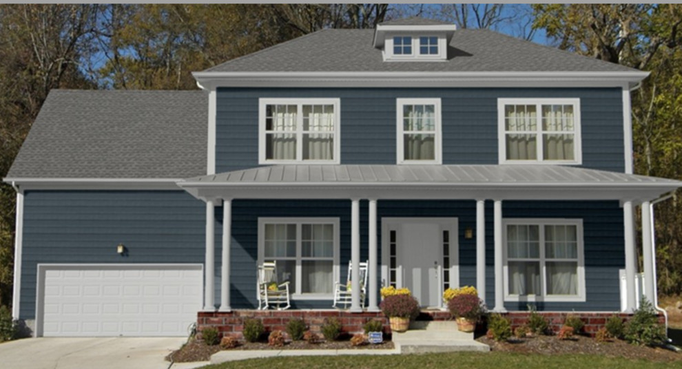 What color plant would compliment a blue house?